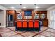 Custom wet bar with wood cabinetry, a stainless fridge, and seating for four at 268 Hanson Way, Marietta, GA 30064
