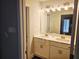 Bathroom featuring double sinks, a large mirror, and modern lighting fixtures at 309 Melanie Ct, Bowdon, GA 30108