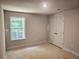 Bright bedroom featuring a large window, spacious closet, and neutral walls at 309 Melanie Ct, Bowdon, GA 30108