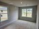 Well-lit bedroom offering views of the neighborhood through two large windows at 309 Melanie Ct, Bowdon, GA 30108