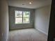 Cozy bedroom with a large window offering natural light and neighborhood views at 309 Melanie Ct, Bowdon, GA 30108