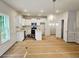 Bright eat-in kitchen features white cabinetry, stainless steel appliances and island at 309 Melanie Ct, Bowdon, GA 30108