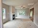 Bright living room with fireplace, ceiling fan, and views to the outdoors at 309 Melanie Ct, Bowdon, GA 30108