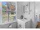 Charming half bath with a white vanity, sink, and a sunlit window at 1050 Boulevard Ne Dr, Atlanta, GA 30317