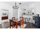 Dining room with hardwood floors, modern lighting, and access to the kitchen and bedroom at 1050 Boulevard Ne Dr, Atlanta, GA 30317