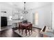 Open dining area with modern light fixture, a keyboard, and dark hardwood floors at 1050 Boulevard Ne Dr, Atlanta, GA 30317