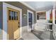 Cozy covered porch features a swing, bright yellow door, and stylish architectural details at 1050 Boulevard Ne Dr, Atlanta, GA 30317