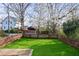 Grassy backyard enclosed by a wooden fence and adorned with a mature shade tree at 213 Oak Ln, Decatur, GA 30030