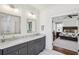 Stylish bathroom featuring double vanity, marble countertops, and access to the primary bedroom at 213 Oak Ln, Decatur, GA 30030