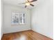 Bright bedroom featuring hardwood floors, a ceiling fan, and a window providing natural light at 213 Oak Ln, Decatur, GA 30030