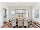 Bright dining room with a modern chandelier, hardwood floors, and ample seating for Gathering and guests at 213 Oak Ln, Decatur, GA 30030