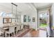 Elegant dining room with a large table, stylish chairs, and natural light streaming through the windows at 213 Oak Ln, Decatur, GA 30030