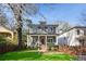 Well-manicured front lawn leading to a charming two-story home with a covered porch and mature landscaping at 213 Oak Ln, Decatur, GA 30030