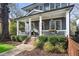 Inviting front porch featuring classic columns, decorative lighting, and lush greenery for a cozy atmosphere at 213 Oak Ln, Decatur, GA 30030