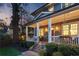 Inviting front porch featuring classic columns, decorative lighting, and meticulously kept landscaping at 213 Oak Ln, Decatur, GA 30030