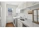 Bright laundry room with modern appliances, marble countertop, sink, and cabinet storage at 213 Oak Ln, Decatur, GA 30030