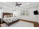 Main bedroom featuring a tray ceiling, wood floors, and a large window at 213 Oak Ln, Decatur, GA 30030