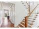 Charming staircase with wooden steps and white railings, illuminated by natural light from a window at 213 Oak Ln, Decatur, GA 30030