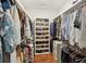 Organized walk-in closet with custom shelving, ample hanging space, and hardwood floors at 213 Oak Ln, Decatur, GA 30030