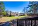 A spacious fenced backyard with a house featuring a brick chimney and a walkout patio at 314 Meadow Spring Dr, Temple, GA 30179