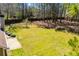 Expansive backyard features lush lawn, mature trees, and a wood privacy fence at 314 Meadow Spring Dr, Temple, GA 30179