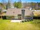 Aerial backyard view of a home with a concrete patio and green grass at 314 Meadow Spring Dr, Temple, GA 30179