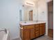 Bathroom featuring a double sink vanity with a large mirror and a view to a closet at 314 Meadow Spring Dr, Temple, GA 30179