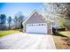 Two-car garage is part of this charming single-story home with mature landscaping at 314 Meadow Spring Dr, Temple, GA 30179