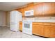 Kitchen featuring white appliances and wooden cabinets at 314 Meadow Spring Dr, Temple, GA 30179