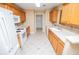 Kitchen with white appliances and wooden cabinets at 314 Meadow Spring Dr, Temple, GA 30179