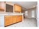 Kitchen with wooden cabinets and view of fireplace at 314 Meadow Spring Dr, Temple, GA 30179