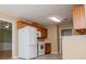 Kitchen featuring white appliances and wooden cabinets at 314 Meadow Spring Dr, Temple, GA 30179