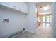 View of laundry room with white cabinets and access to the kitchen and backyard at 314 Meadow Spring Dr, Temple, GA 30179