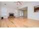 Spacious living room with hardwood floors, stone fireplace, and neutral paint colors at 314 Meadow Spring Dr, Temple, GA 30179