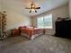 Comfortable bedroom boasts natural light, neutral walls, ceiling fan, and plush carpet at 401 Carrie Kathleen Ter, Carrollton, GA 30116