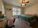 Welcoming bedroom featuring a ceiling fan, soft carpet, and window overlooking the backyard at 401 Carrie Kathleen Ter, Carrollton, GA 30116