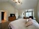 Bright main bedroom featuring high vaulted ceiling, ceiling fan, and view to the connected sitting room at 401 Carrie Kathleen Ter, Carrollton, GA 30116