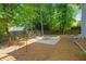 Great backyard featuring a fire pit on a patio, surrounded by mature trees and wooden fence at 4956 Braeburn Nw Trce, Acworth, GA 30102