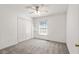 Clean bedroom featuring neutral carpet, a ceiling fan, and a closet with shelving at 4956 Braeburn Nw Trce, Acworth, GA 30102