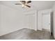 This carpeted bedroom offers a ceiling fan, closet, and an open doorway at 4956 Braeburn Nw Trce, Acworth, GA 30102