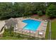 Aerial view of a community pool surrounded by lounge chairs and lush landscaping at 4956 Braeburn Nw Trce, Acworth, GA 30102