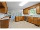 Open kitchen area with wood cabinets, stainless steel appliances, and access to an enclosed porch at 4956 Braeburn Nw Trce, Acworth, GA 30102