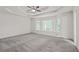 Spacious main bedroom featuring a tray ceiling, and many windows allowing natural light at 4956 Braeburn Nw Trce, Acworth, GA 30102