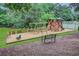 A charming community playground featuring a play structure and swings surrounded by landscaping at 4956 Braeburn Nw Trce, Acworth, GA 30102