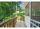 Outdoor porch with wooden railing overlooking backyard trees at 4956 Braeburn Nw Trce, Acworth, GA 30102
