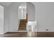 Carpeted staircase featuring an arched entryway and hardwood floors at 4956 Braeburn Nw Trce, Acworth, GA 30102