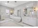 Luxurious bathroom featuring a freestanding tub, marble accents, and dual vanities at 6616 Aria Village Dr, Atlanta, GA 30328