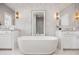 Stunning bathroom with a freestanding tub, double vanity, and marble wall accents at 6616 Aria Village Dr, Atlanta, GA 30328