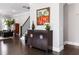 Home foyer with hardwood floors, neutral paint, modern art, and black railing staircase at 6616 Aria Village Dr, Atlanta, GA 30328