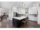 Modern kitchen with a large island, stainless appliances and opens to living spaces at 6616 Aria Village Dr, Atlanta, GA 30328